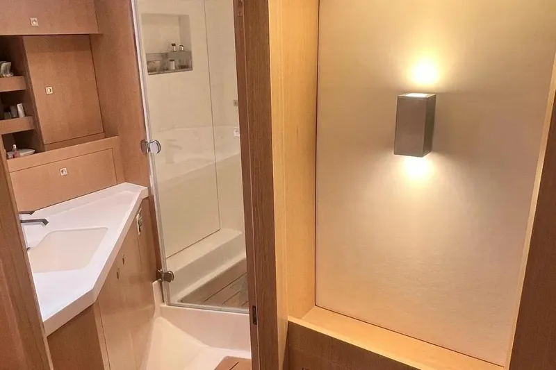  Yacht Photos Pics Luxurious bathroom interior of 2016 Amel 64 yacht with modern lighting and wooden finishes.