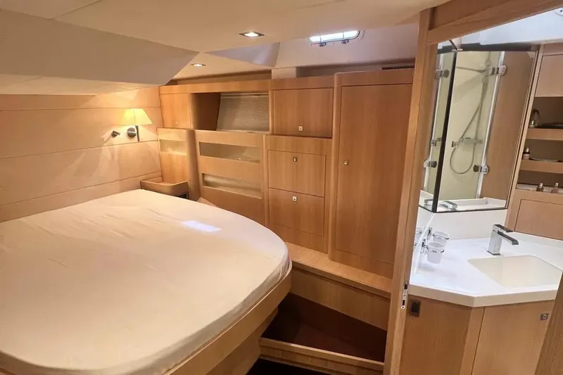  Yacht Photos Pics Luxurious cabin interior of 2016 Amel 64 yacht with modern wood finish.