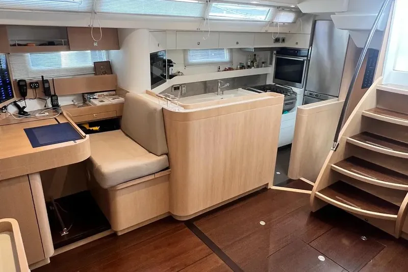  Yacht Photos Pics Luxurious interior of a 2016 Amel 64 yacht featuring modern kitchen and seating area.