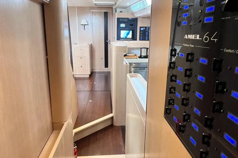  Yacht Photos Pics Interior of 2016 Amel 64 yacht, featuring modern control panel and sleek wooden design.
