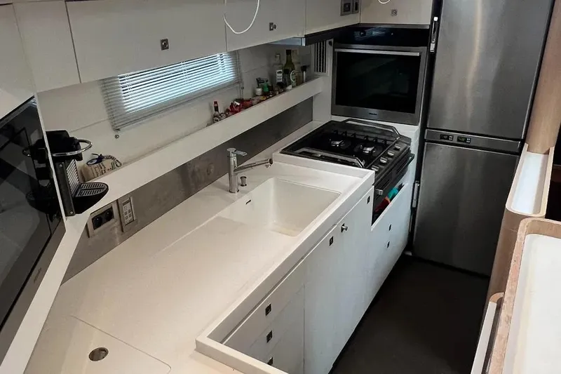  Yacht Photos Pics Modern kitchen in a 2016 Amel 64 yacht with sleek appliances and white cabinetry.