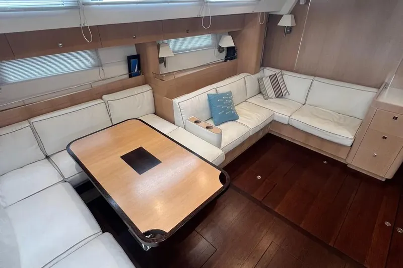  Yacht Photos Pics Luxurious interior of a 2016 Amel 64 yacht with elegant seating and wooden table.