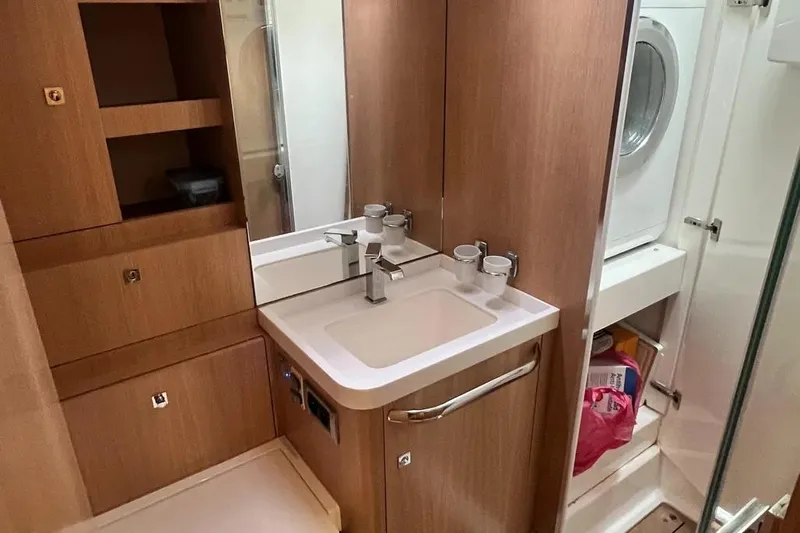  Yacht Photos Pics Modern bathroom with sink, storage, and washer in 2016 Amel 64 yacht.