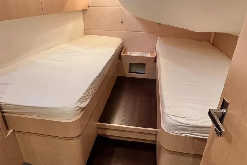  Yacht Photos Pics Interior cabin of 2016 Amel 64 yacht with twin beds and wooden finish.