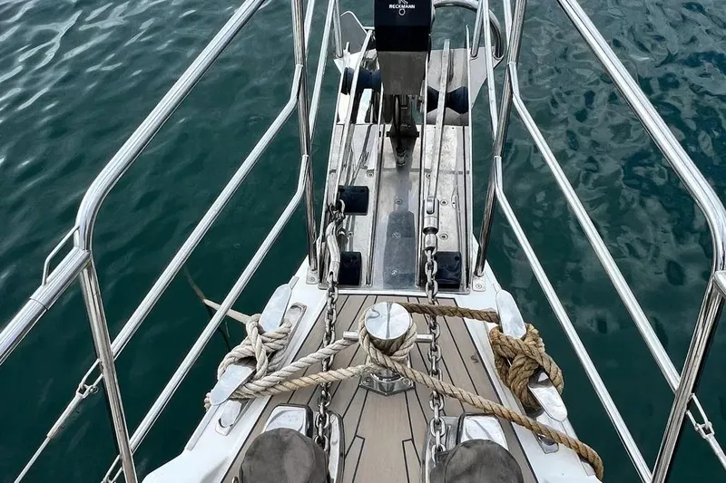  Yacht Photos Pics Bow of 2016 Amel 64 yacht with ropes and anchor over calm water.