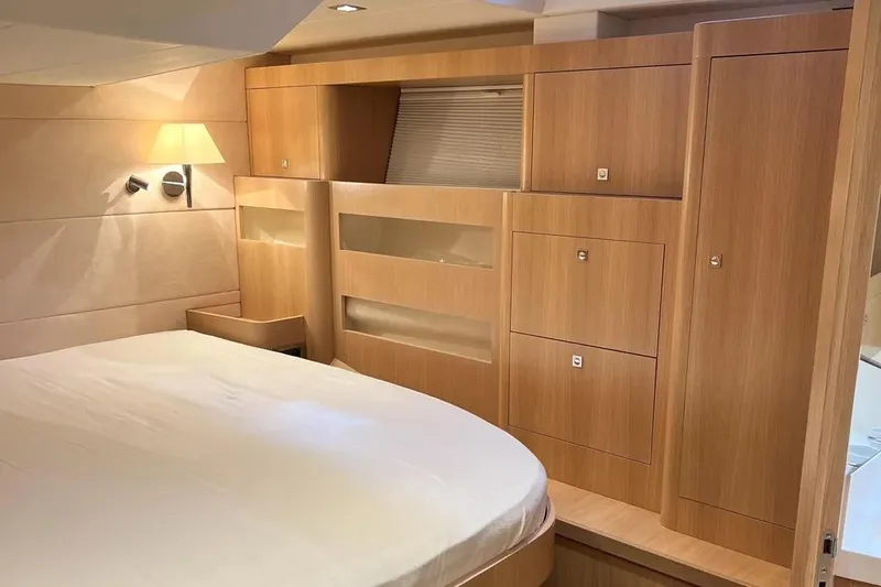  Yacht Photos Pics Luxurious cabin interior of a 2016 Amel 64 yacht with wooden furnishings.