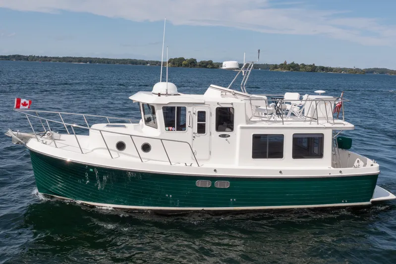 William B Yacht Photos Pics 2003 American Tug 34 cruising on a lake with Canadian flag displayed.