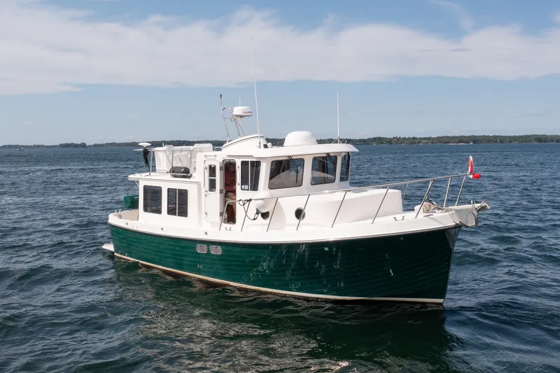 William B Yacht Photos Pics 2003 American Tug 34 cruising on open water under a clear sky.