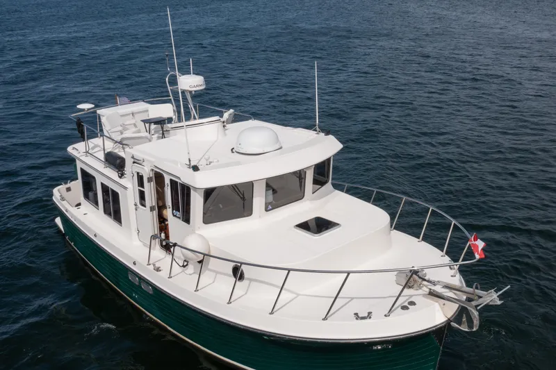 William B Yacht Photos Pics 2003 American Tug 34 cruising on open water, showcasing its sturdy design and sleek profile.