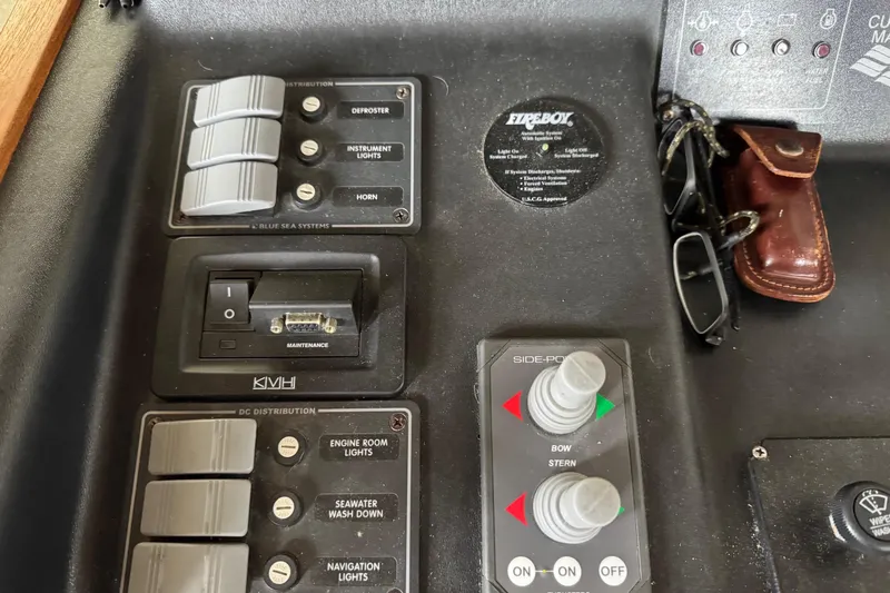 William B Yacht Photos Pics Control panel of a 2003 American Tug 34 boat with various switches and knobs.