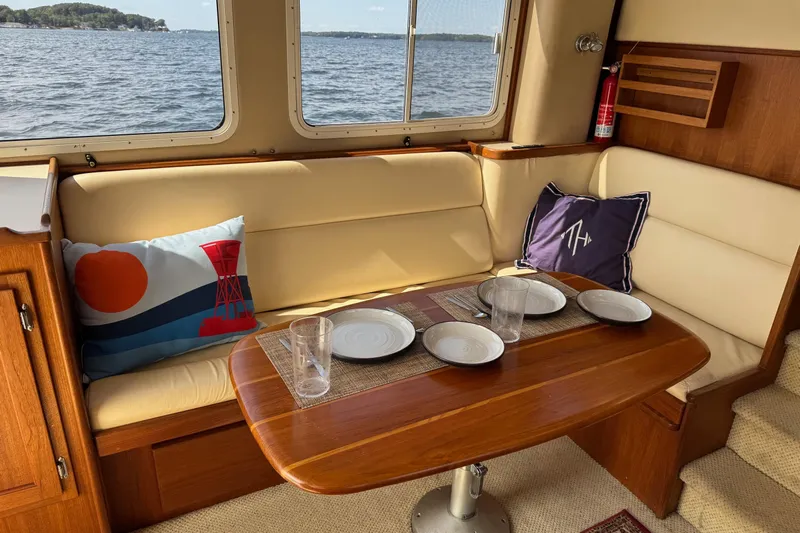 William B Yacht Photos Pics Cozy dining area in a 2003 American Tug 34 with scenic water view.