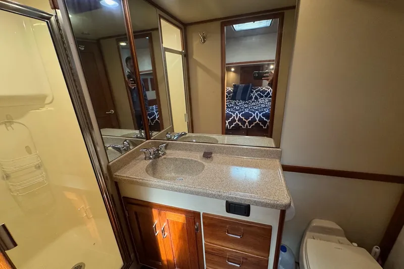 William B Yacht Photos Pics Bathroom interior of 2003 American Tug 34 with sink, mirror, and shower.