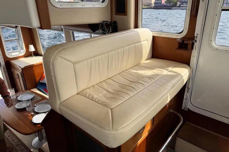 William B Yacht Photos Pics Interior of 2003 American Tug 34 with cream leather seating and dining area.