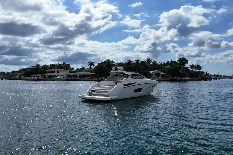 Princessita Yacht Photos Pics 2014 Azimut Atlantis yacht cruising on a sunny day with scenic waterfront views.