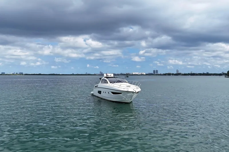 Princessita Yacht Photos Pics Luxury 2014 Azimut Atlantis yacht on calm waters under cloudy sky.