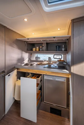 In Stock Yacht Photos Pics 2023 Beneteau Gran Turismo 41 yacht kitchen with modern appliances and sleek cabinetry.