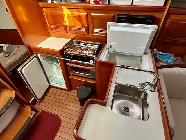 Golden Handcuffs Yacht Photos Pics Interior of 2007 Beneteau 373 sailboat kitchen with stove, fridge, and sink.