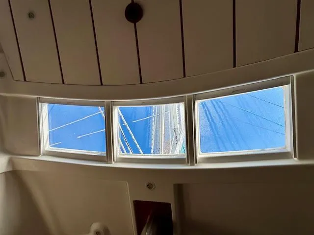 Golden Handcuffs Yacht Photos Pics Interior view from a 2007 Beneteau 373 sailboat, showcasing windows and mast.