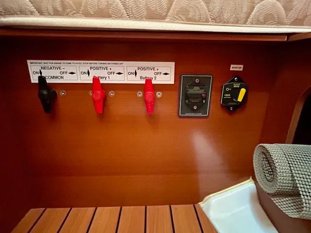 Golden Handcuffs Yacht Photos Pics Battery control panel on a 2007 Beneteau 373 sailboat interior.