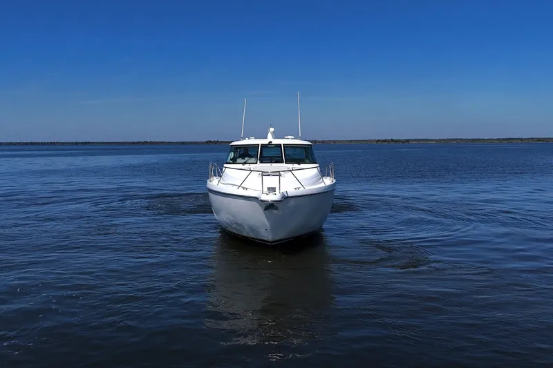 Chico Malo Yacht Photos Pics 2008 Tiara Yachts 4300 Sovran cruising on open water under clear blue skies.