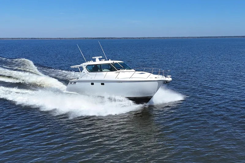 Chico Malo Yacht Photos Pics 2008 Tiara Yachts 4300 Sovran cruising on open water under clear blue skies.