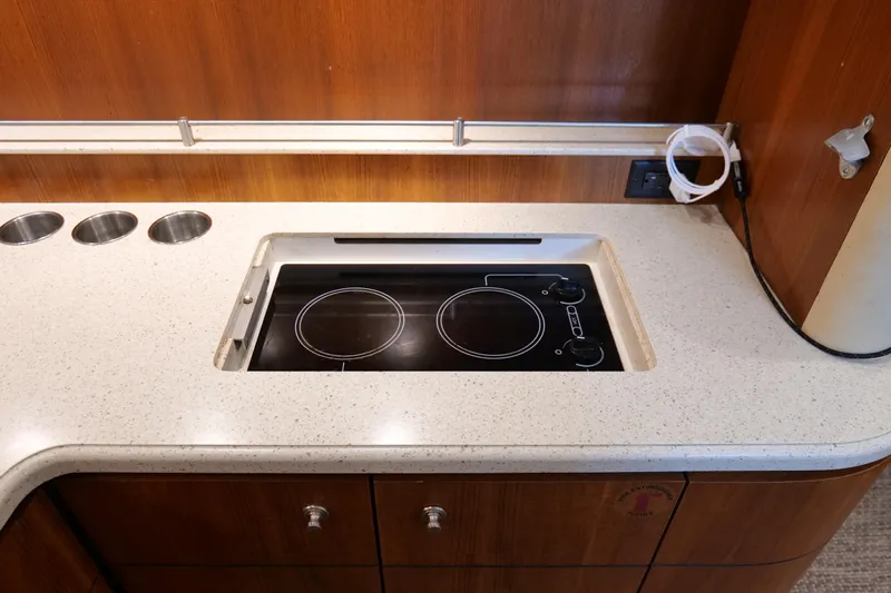 Chico Malo Yacht Photos Pics 2008 Tiara Yachts 4300 Sovran kitchen with electric stovetop and sleek countertop design.