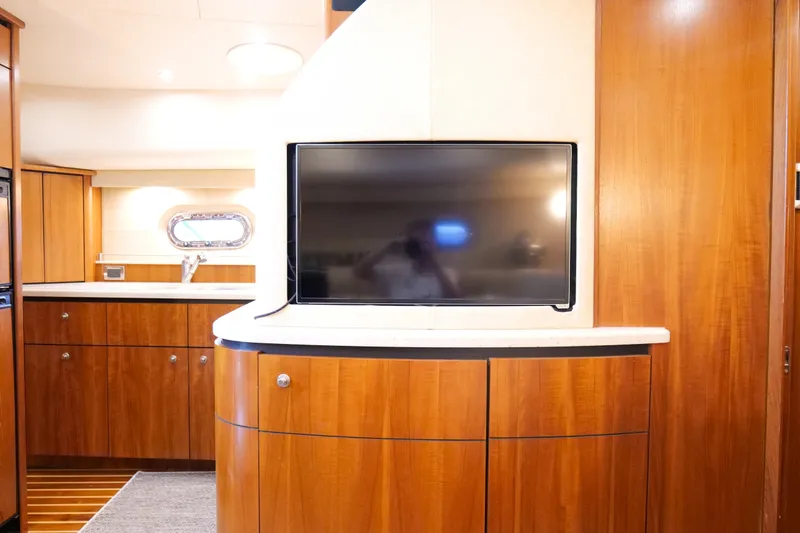 Chico Malo Yacht Photos Pics Luxurious 2008 Tiara Yachts 4300 Sovran interior with wood cabinetry and flat-screen TV.