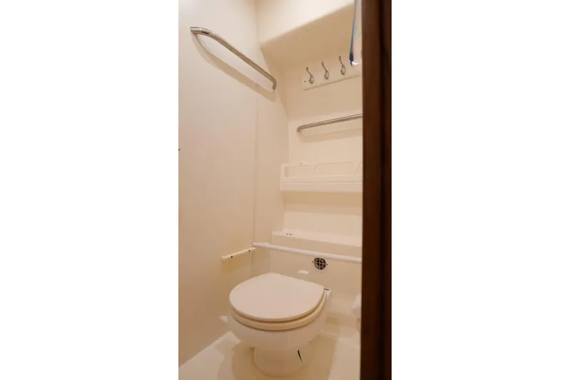 Chico Malo Yacht Photos Pics Compact bathroom in 2008 Tiara Yachts 4300 Sovran, featuring toilet and storage hooks.
