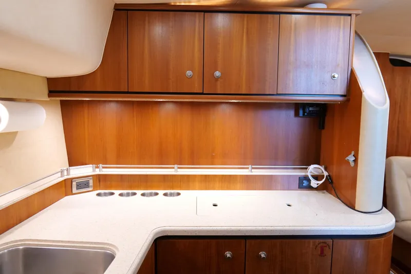 Chico Malo Yacht Photos Pics 2008 Tiara Yachts 4300 Sovran galley with wooden cabinets and modern countertop.