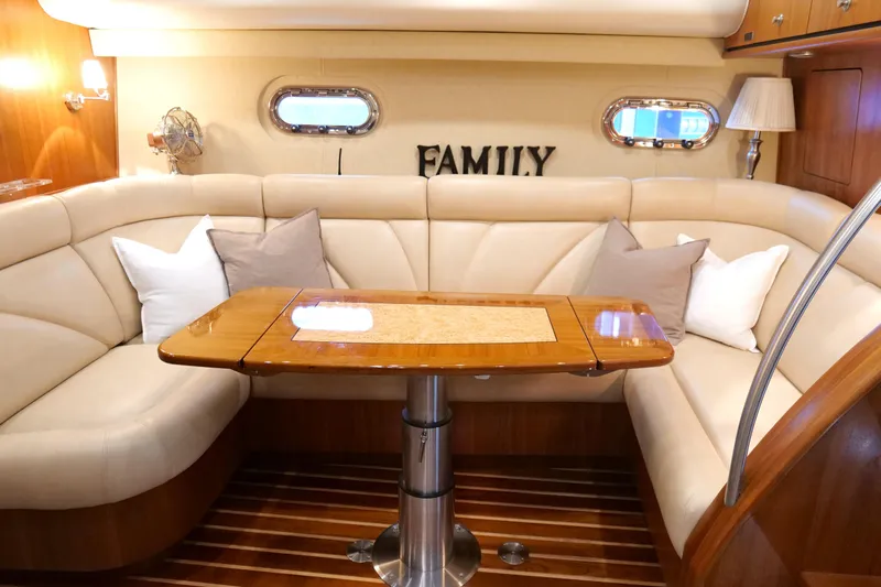 Chico Malo Yacht Photos Pics Luxurious interior of 2008 Tiara Yachts 4300 Sovran with elegant seating and wooden table.