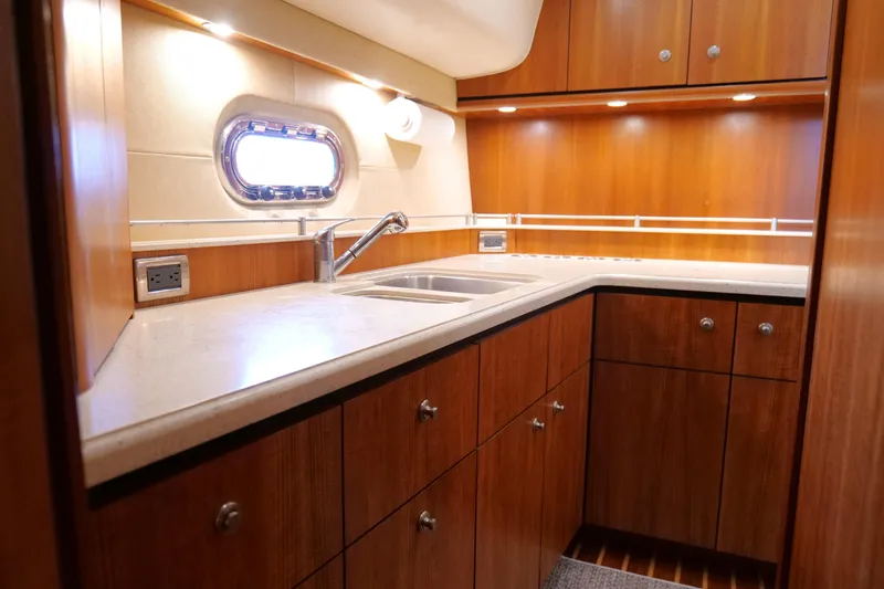 Chico Malo Yacht Photos Pics Luxurious 2008 Tiara Yachts 4300 Sovran kitchen with wood cabinetry and modern fixtures.