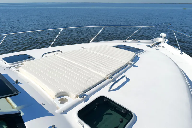 Chico Malo Yacht Photos Pics 2008 Tiara Yachts 4300 Sovran deck with sunpad, overlooking calm blue waters.