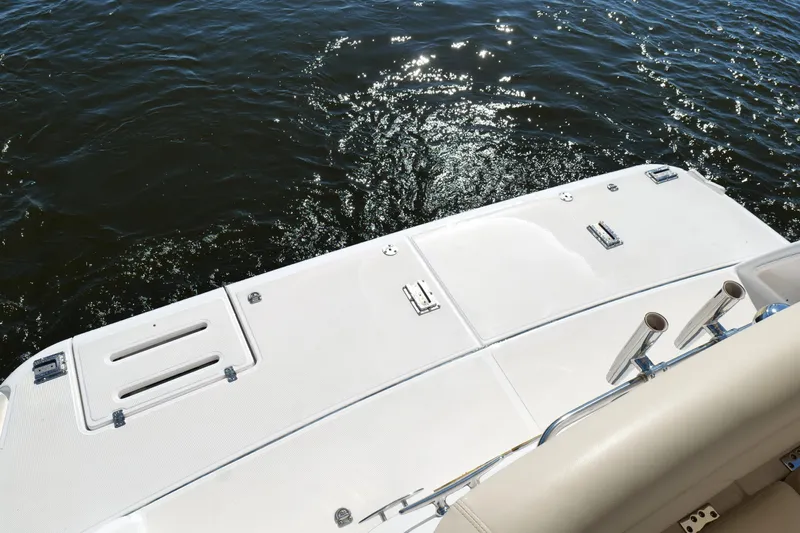 Chico Malo Yacht Photos Pics 2008 Tiara Yachts 4300 Sovran swim platform with rod holders, overlooking sparkling water.