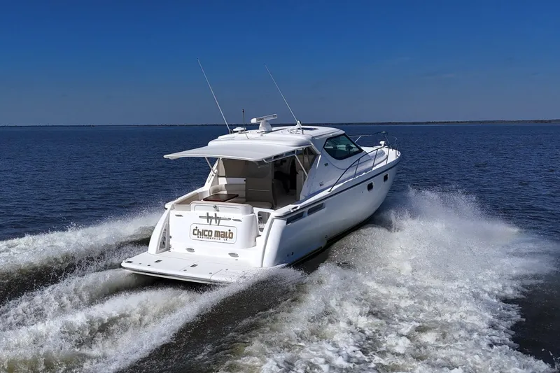 Chico Malo Yacht Photos Pics 2008 Tiara Yachts 4300 Sovran cruising on open water under clear blue sky.