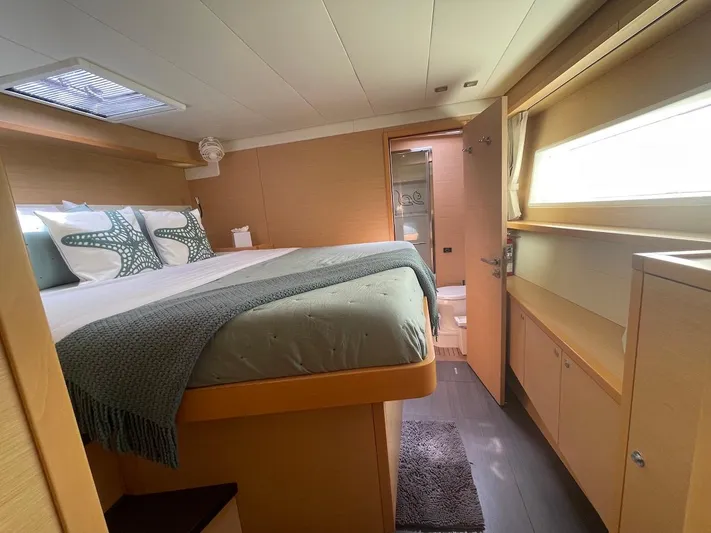  Yacht Photos Pics Luxurious cabin interior of 2015 Lagoon 52 F yacht with cozy bed and modern design.