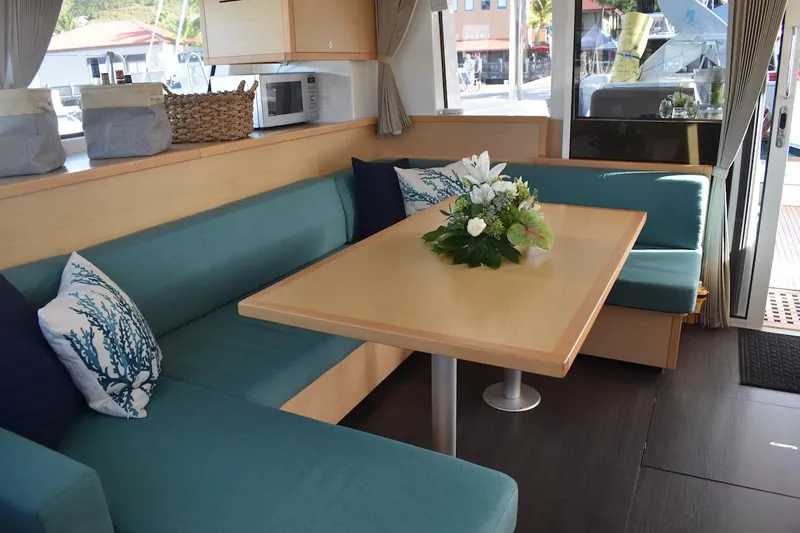  Yacht Photos Pics Interior of 2015 Lagoon 52 F yacht with cozy seating and elegant table setting.