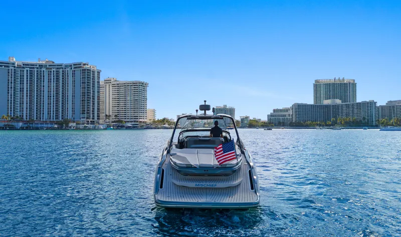 Mischief Yacht Photos Pics Luxury Princess R35 yacht cruising near city skyline, 2021 model.