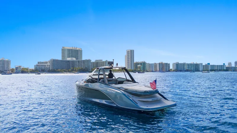 Mischief Yacht Photos Pics Luxury Princess R35 yacht cruising near city skyline, 2021 model, with American flag.