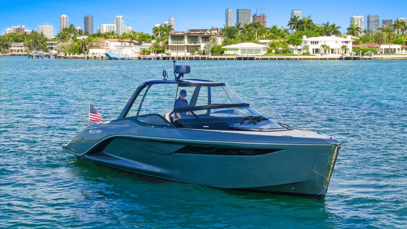 Mischief Yacht Photos Pics Luxury Princess R35 yacht cruising near a coastal city, 2021 model.