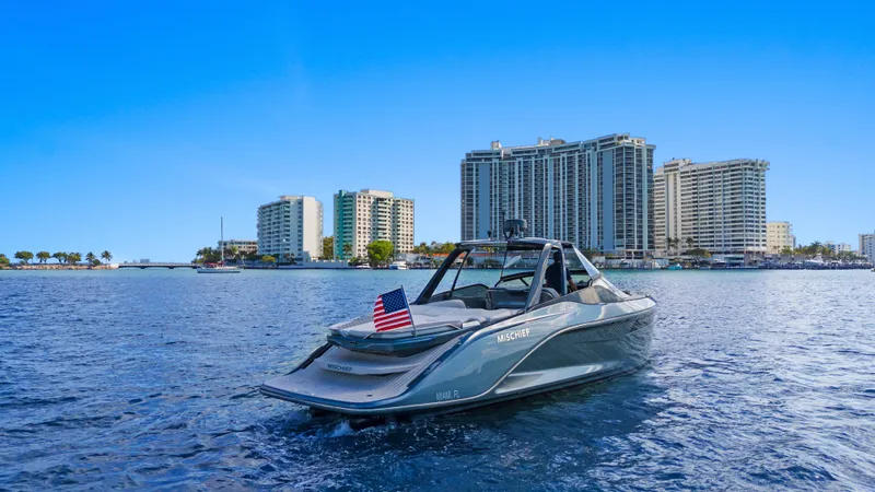 Mischief Yacht Photos Pics 2021 Princess R35 boat on water with city skyline in background.