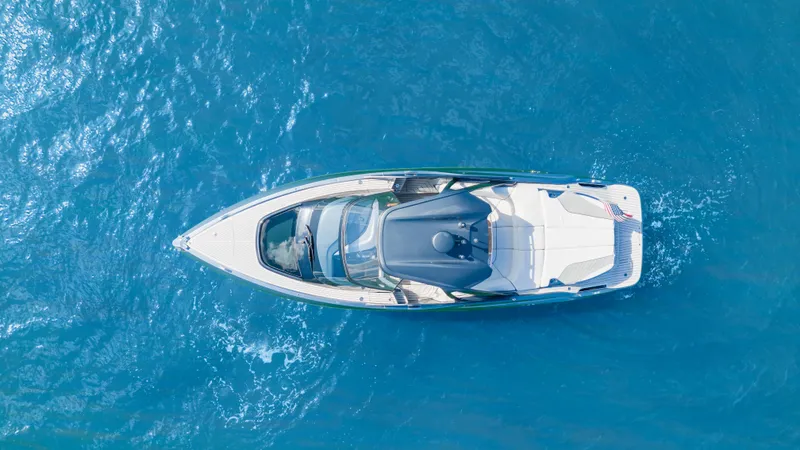 Mischief Yacht Photos Pics Aerial view of 2021 Princess R35 yacht cruising on clear blue water.