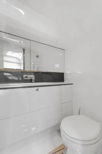 Mischief Yacht Photos Pics Modern bathroom in 2021 Princess R35 yacht, featuring sleek white design and elegant fixtures.