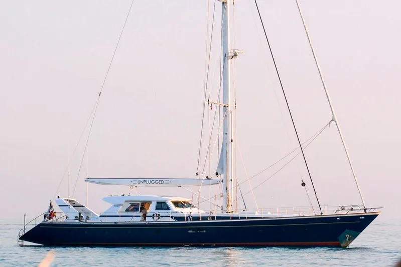 Unplugged Yacht Photos Pics Valdettaro 112 yacht from 1993, named "Unplugged," sailing on calm waters.