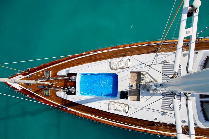 Unplugged Yacht Photos Pics Aerial view of 1993 Valdettaro 112 yacht with wooden deck and blue pool.