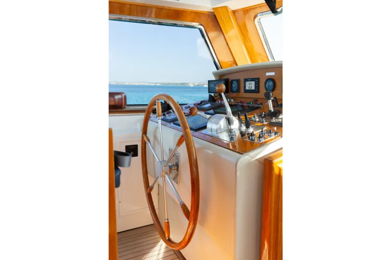 Unplugged Yacht Photos Pics Valdettaro 112 yacht helm, 1993 model, featuring wooden steering wheel and control panel.