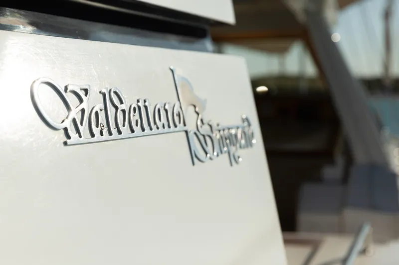 Unplugged Yacht Photos Pics Valdettaro 112 yacht emblem, 1993 model, close-up view with blurred background.