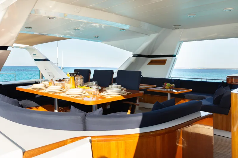 Unplugged Yacht Photos Pics Luxurious dining area on 1993 Valdettaro 112 yacht with ocean view.