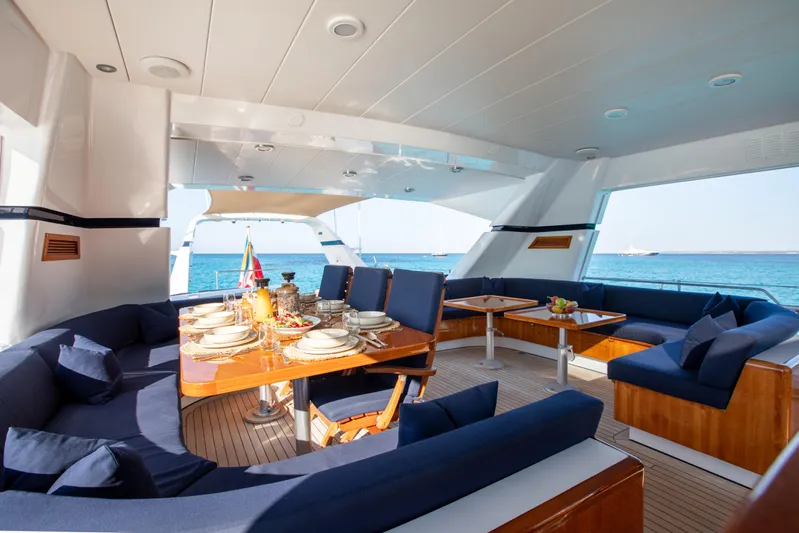 Unplugged Yacht Photos Pics Luxurious 1993 Valdettaro 112 yacht interior with elegant dining setup and ocean view.