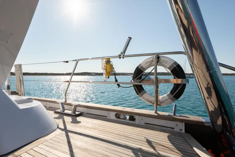Unplugged Yacht Photos Pics Deck view of 1993 Valdettaro 112 yacht with lifebuoy and ocean backdrop.