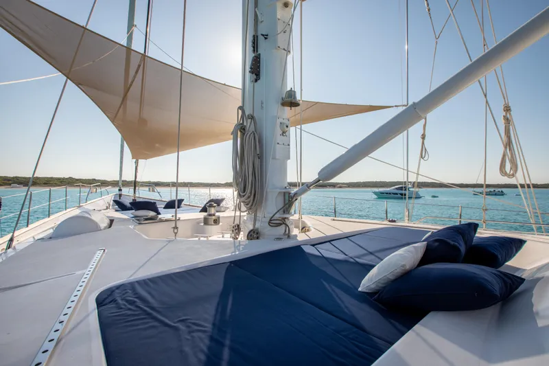 Unplugged Yacht Photos Pics Luxurious 1993 Valdettaro 112 yacht deck with sunbathing area and ocean view.